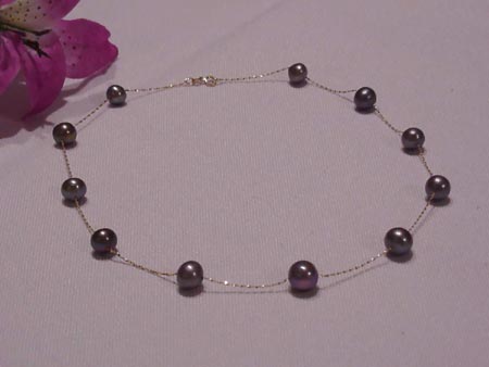 7.0-7.8mm round black pearl tin cup necklace with 14kt gold chain and clasp.