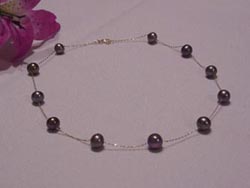 7.0-7.8mm round black pearl tin cup necklace with 14kt gold chain and clasp.